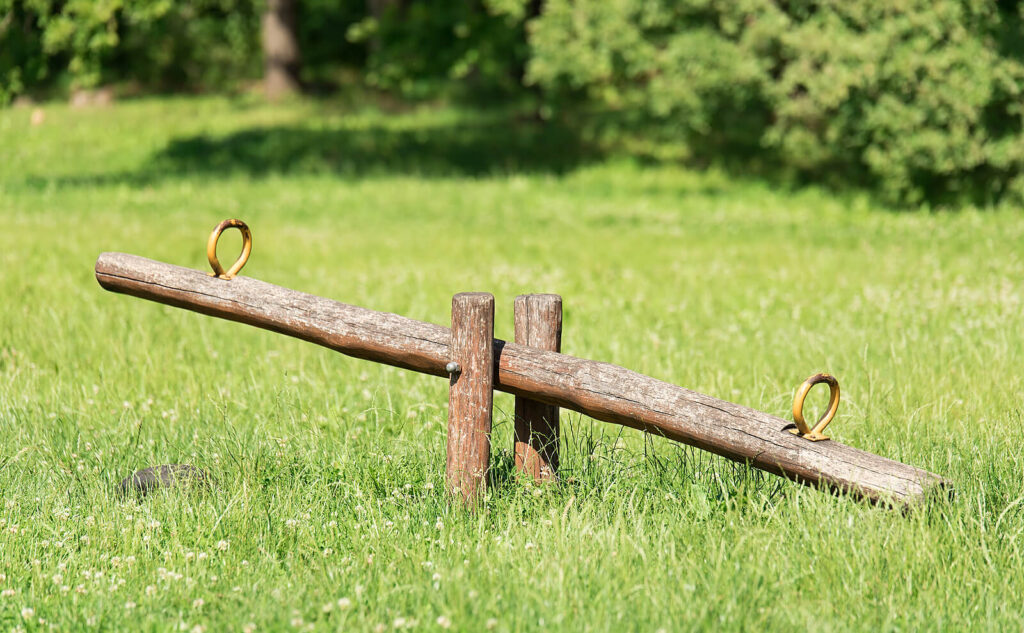 Image of a wooden see-saw. Begin healing from the anxiety symptoms you suffer from with the help of anxiety therapy in Manhattan Beach, CA.