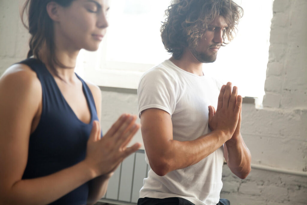 Image of a man and woman practicing yoga. Break free from the cycle of anxiety and begin healing with a skilled anxiety therapist in Manhattan Beach, CA.